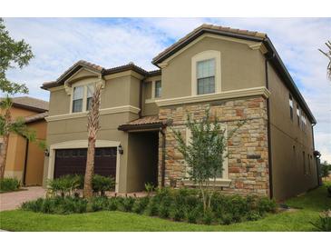 Stunning two-story home featuring a stone facade, well-maintained landscaping, and a two-car garage at 2147 Tripoli Ct, Kissimmee, FL 34747