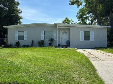 Charming single-story home featuring a well-maintained lawn and a classic concrete driveway at 921 Alecon Dr, Orlando, FL 32808