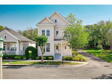 Charming two-story home featuring a covered front porch, landscaped yard, and inviting curb appeal at 121 Longview Ave, Celebration, FL 34747