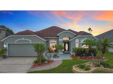 Charming single-story home boasts a well-manicured lawn and inviting front entrance with lush landscaping at 12445 Bohannon Blvd, Orlando, FL 32824