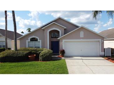 Charming single-Gathering home with a well-maintained lawn, blue door, and two-car garage at 4707 Pershoie Ln, Kissimmee, FL 34746