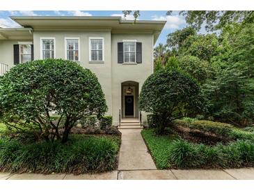 Charming home entrance with manicured bushes along the walkway to the door and a wreath at 1321 Artisan E Ave, Celebration, FL 34747