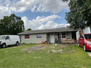 Modest single-story home featuring a simple front yard, awaiting a touch of landscaping at 2329 W Doris St, Kissimmee, FL 34741