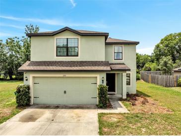 Two-story home featuring an attached two-car garage, neutral color scheme and well-maintained landscaping at 320 Southern Winds Blvd, Deland, FL 32720