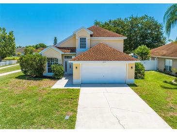 Inviting two-story home with a well-manicured lawn and attached two-car garage at 3203 Herons Point Cir, Kissimmee, FL 34741