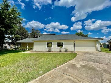 Charming single-story home featuring a well-manicured lawn and an attached two-car garage at 7200 Green Pine Ct, Orlando, FL 32819