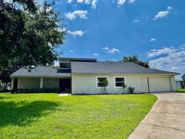 Charming single-story home boasts a lush lawn and attached two-car garage at 7200 Green Pine Ct, Orlando, FL 32819