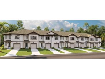 Exterior view of white townhomes with attached garages, manicured lawns, and neutral roofs at 726 Longboat, Davenport, FL 33896