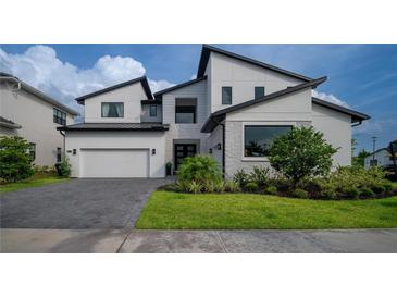 Stunning two-story home with modern architecture, manicured lawn, and a spacious two car garage at 9004 Santorini Dr, Orlando, FL 32827