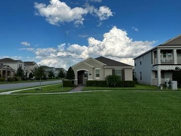 Charming single-story home featuring lush green lawn and inviting curb appeal on a sunny day at 9318 Mclaren Aly, Winter Garden, FL 34787