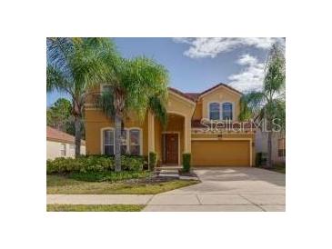 Charming two-story home with a two-car garage and beautiful landscaping, including lush palm trees at 1101 Marcello Blvd, Kissimmee, FL 34746