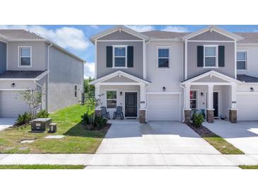 Charming two-story townhome featuring a private garage and a welcoming front porch at 2845 Pierr St, Davenport, FL 33837