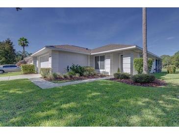 A lovely single-story home boasts a lush green lawn and well-maintained landscaping at 2908 Sunset Lakes Blvd, Kissimmee, FL 34747