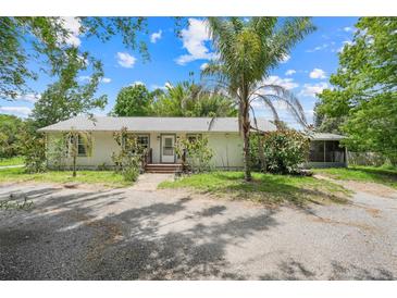 Charming single-story home with a neutral exterior, well-maintained landscaping, and a welcoming front entrance at 429 Diamond Acres Rd, Davenport, FL 33837