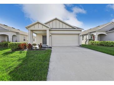 Charming single-story home with a two-car garage, landscaped yard, and covered front porch at 4324 Desert Rose, Kissimmee, FL 34746