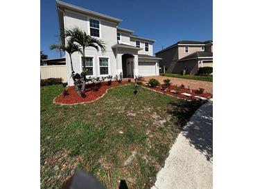 Well-maintained front yard featuring fresh mulch and beautiful landscaping at 4804 Marcos Cir, Kissimmee, FL 34758