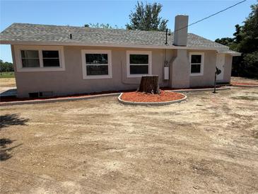 Charming one-story home with a gray roof, featuring a neat landscape and a lovely chimney at 6100 Skokie Rd, Lake Wales, FL 33898