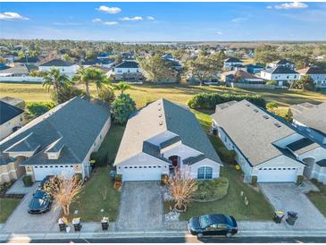 Aerial view of a single-Gathering home showcasing well-manicured lawns and neighborhood at 620 Old Bridge Cir, Davenport, FL 33897