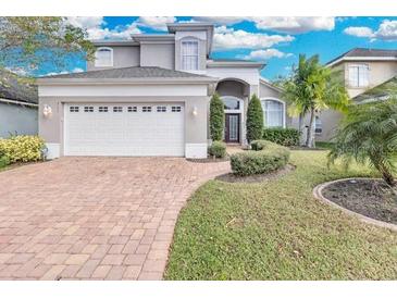 Charming two-story home with a well-manicured lawn and welcoming curb appeal at 721 Hardwood Cir, Orlando, FL 32828