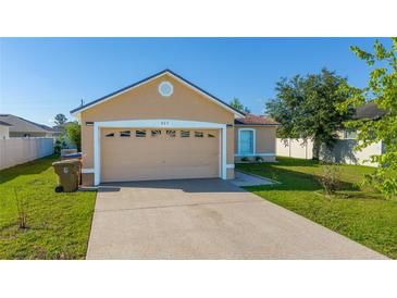 Charming single-story home featuring a two-car garage and well-maintained lawn at 802 Massy Ct, Kissimmee, FL 34759