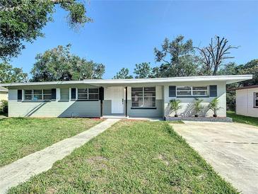 Charming single-story home with a well-manicured lawn and inviting walkway at 220 Hillside Dr, Lakeland, FL 33803