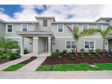Charming two-story townhouse with a well-maintained lawn and landscaping at 4832 Dedication St, Kissimmee, FL 34746