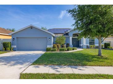 Charming one-story home with manicured landscaping and a gray exterior at 501 Pheasant Dr, Haines City, FL 33844