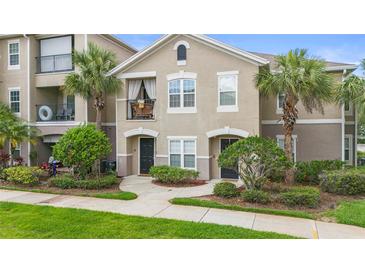 Inviting two-story townhouse with a charming balcony and well-manicured landscaping at 6548 Swissco Dr # 61, Orlando, FL 32822