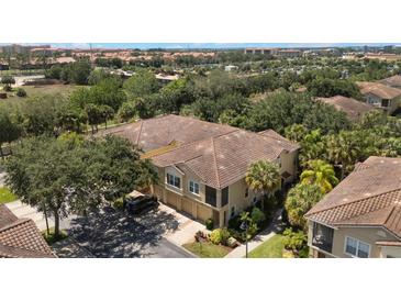 An aerial view of the townhome showcases its well maintained exterior, surrounded by mature landscaping and nearby community at 7521 Pellham Way, Kissimmee, FL 34747