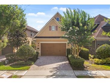 Charming home featuring a two-car garage, neat landscaping, and a brick driveway at 781 Golden Bear Dr, Kissimmee, FL 34747