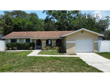 Charming single-Gathering home with an attached one-car garage, arched entryway, and neatly kept landscaping at 114 N Alderwood St, Winter Springs, FL 32708
