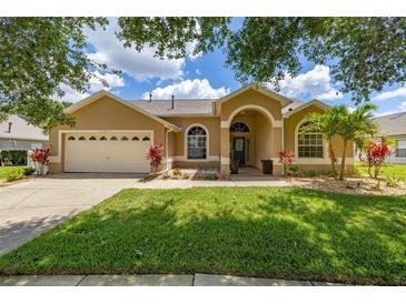Charming single-story home featuring a well-manicured lawn and inviting curb appeal at 3125 Samosa Hill Cir, Clermont, FL 34714