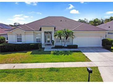 Charming single-story home featuring manicured lawn, attached two-car garage, and lovely landscaping in a desirable location at 426 Prestwick Dr, Davenport, FL 33897