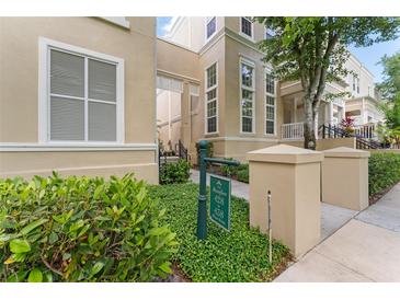 Beautiful townhome exterior with manicured landscaping and visible unit number signage at 438 Water St # 438, Celebration, FL 34747