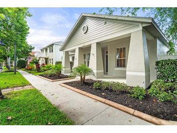 Well-maintained home exterior featuring manicured landscaping and a cozy front porch at 7013 Beargrass Rd, Harmony, FL 34773