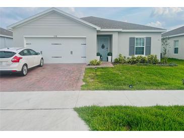Charming one-story home with a well-maintained front yard and brick paver driveway at 1190 Lexington Lane, Haines City, FL 33844