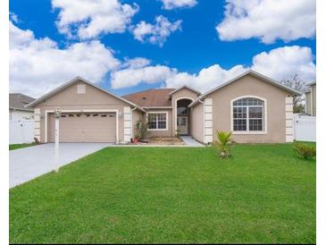 Charming single-story home with a well-manicured lawn and attached two car garage at 143 Brixham Ct, Kissimmee, FL 34758