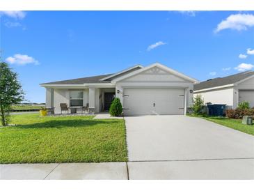 Charming single-story home with a well-manicured lawn and a two-car garage at 1524 Fleur Dr, Davenport, FL 33837