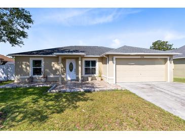 Charming single-story home featuring a well-maintained lawn and a two-car garage at 2454 Quail Run N Blvd, Kissimmee, FL 34744
