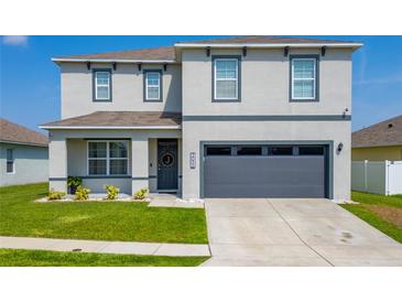 Charming two-story home with a well-manicured lawn and an attached two-car garage at 3053 Royal Tern Dr, Winter Haven, FL 33881