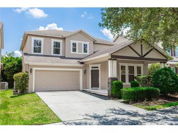 Inviting two-story home featuring a neutral color palette, attached garage, and a well-maintained lawn and landscaping at 6957 Northwich Dr, Windermere, FL 34786
