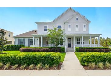 Charming two-story home with a covered porch and professionally landscaped front yard at 7400 Estuary Lake Loop, Celebration, FL 34747