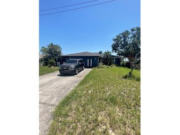 Charming single-story home with a well-kept lawn, driveway, and dark exterior paint at 848 Wildabon Ave, Lake Wales, FL 33853