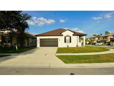 Charming single-story home with a well-maintained lawn and a two-car garage, perfect for suburban living at 1025 Belvoir Dr, Kissimmee, FL 34744