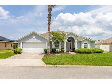Charming single-story home featuring a two-car garage, manicured lawn, and beautiful landscaping at 252 Barbera Dr, Davenport, FL 33897