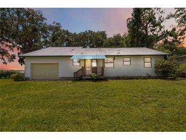 Charming single-story home with a metal roof and well-maintained lawn at 2740 Barker Rd, St Cloud, FL 34771