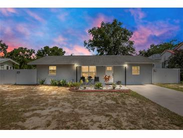 Charming single-story home featuring a well-manicured lawn, white fence, and inviting curb appeal at 416 E Seminole Ave, Lake Wales, FL 33853
