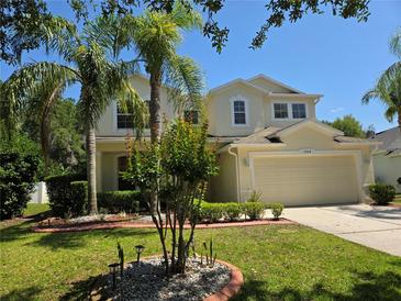 Charming two-story home with a well manicured lawn and beautiful landscaping at 5704 Ansley Way, Mount Dora, FL 32757