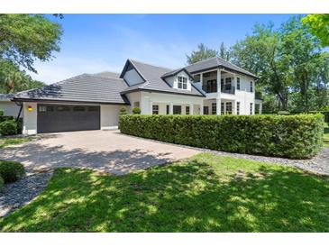 Stunning two-story home featuring a manicured front lawn and a spacious driveway leading to a two-car garage at 9799 Covent Garden Dr, Orlando, FL 32827