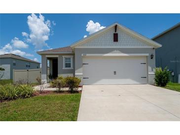 Charming single-story home with a two-car garage and well-maintained lawn at 1015 Andean Ln, Davenport, FL 33837